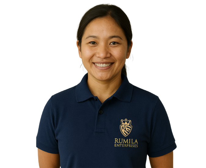 A smiling Darjeeling maid standing in a clean Delhi home.